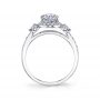 Side profile of a white gold three stone diamond engagement ring with a halo around the center diamond from the Sylvie Collection