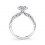 Side profile of a white gold diamond engagement ring from the Sylvie Collection featuring a twisting diamond shank accompanying a round diamond halo