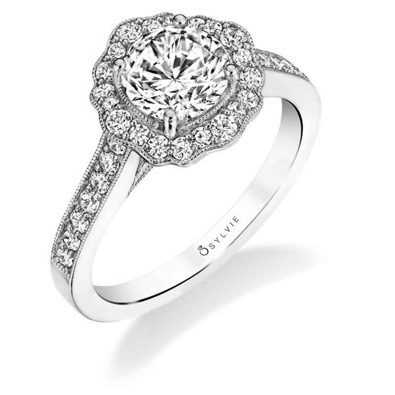 A white gold diamond engagement ring from the Sylvie Collection featuring a floral milgrain accented halo