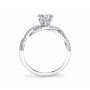 Side profile of a white gold diamond engagement ring from the Sylvie Collection featuring a twisting diamond shank and round diamond