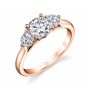 A rose gold diamond engagement ring from the Sylvie Collection featuring a large round diamond with a slightly smaller round diamond on either side