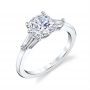 A white gold three stone diamond engagement ring from the Sylvie Collection featuring a large round diamond in the center with two baguette cut diamonds on the side
