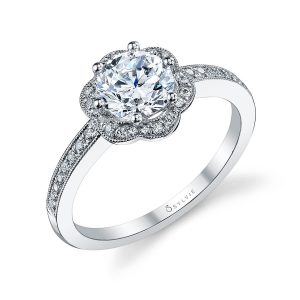 A white gold diamond engagement ring featuring a milgrain accented floral shaped halo
