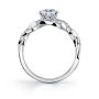 Side profile of a white gold diamond engagement ring from the Sylvie Collection featuring a large center diamond and a weaving diamond shank with milgrain accents