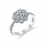A white gold diamond engagement ring with eight bezel set diamond around a center stone