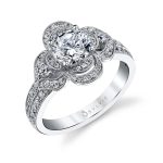 A floral themed white gold diamond engagement ring from the Sylvie Collection with "petals" set with diamonds around a round diamond