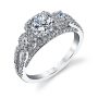 A white gold three stone diamond ring with halos from the Sylvie Collection