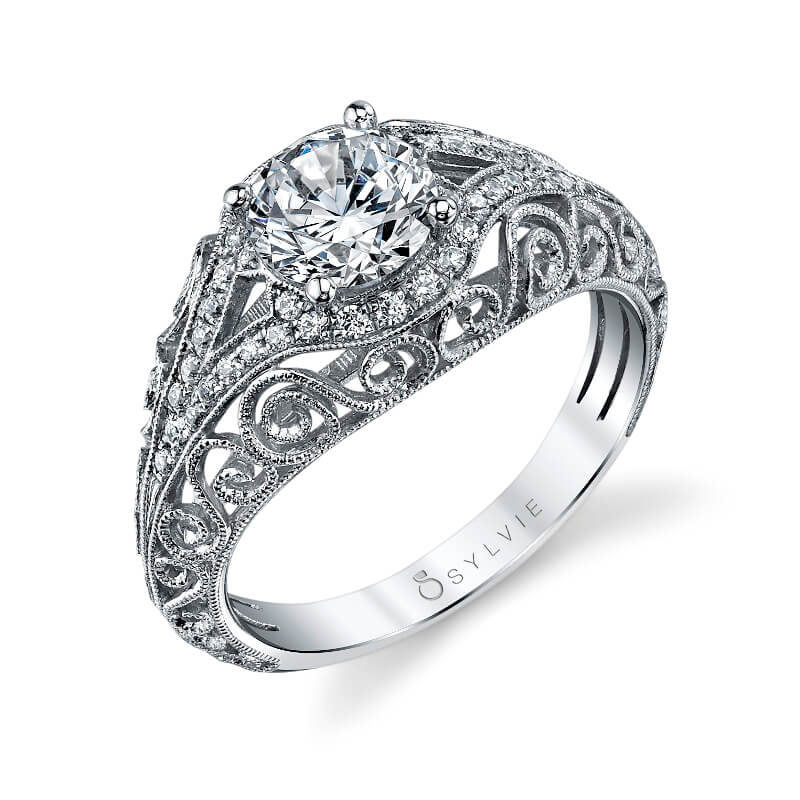 A white gold diamond engagement ring from the Sylvie Collection with sweeping curved designs