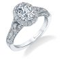 A white gold diamond engagement ring from the Sylvie Collection featuring an oval shaped diamond in the center of a halo mounting with milgrain accents and an art deco style
