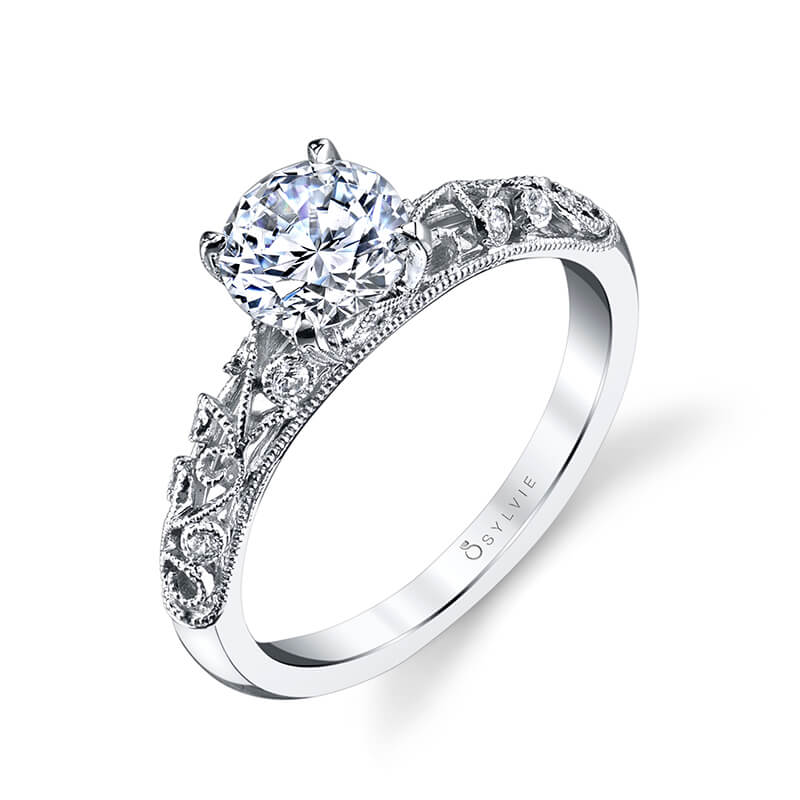 A white gold diamond engagement ring from the Sylvie Colleciton featuring diamond accented swirls and a large prong set diamond