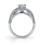 Side profile of a white gold diamond engagement ring from the Sylvie Collection featuring a large round diamond inside a swirling diamond mounting