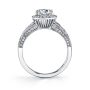 Side profile of a white gold diamond engagement ring featuring a cushion shaped halo around a round diamond with milgrain accents