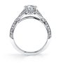 Side profile of a white gold diamond engagement ring from the Sylvie Collection featuring a round diamond in the center and a twisting split shank with diamonds and milgrain accents