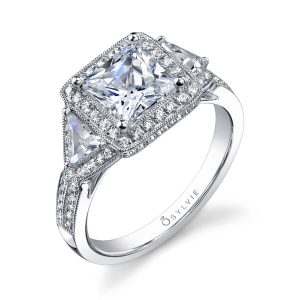 White gold diamond engagement ring featuring a large princess cut diamond with a halo and two accompanying triangle cut diamonds from the Sylvie Collection